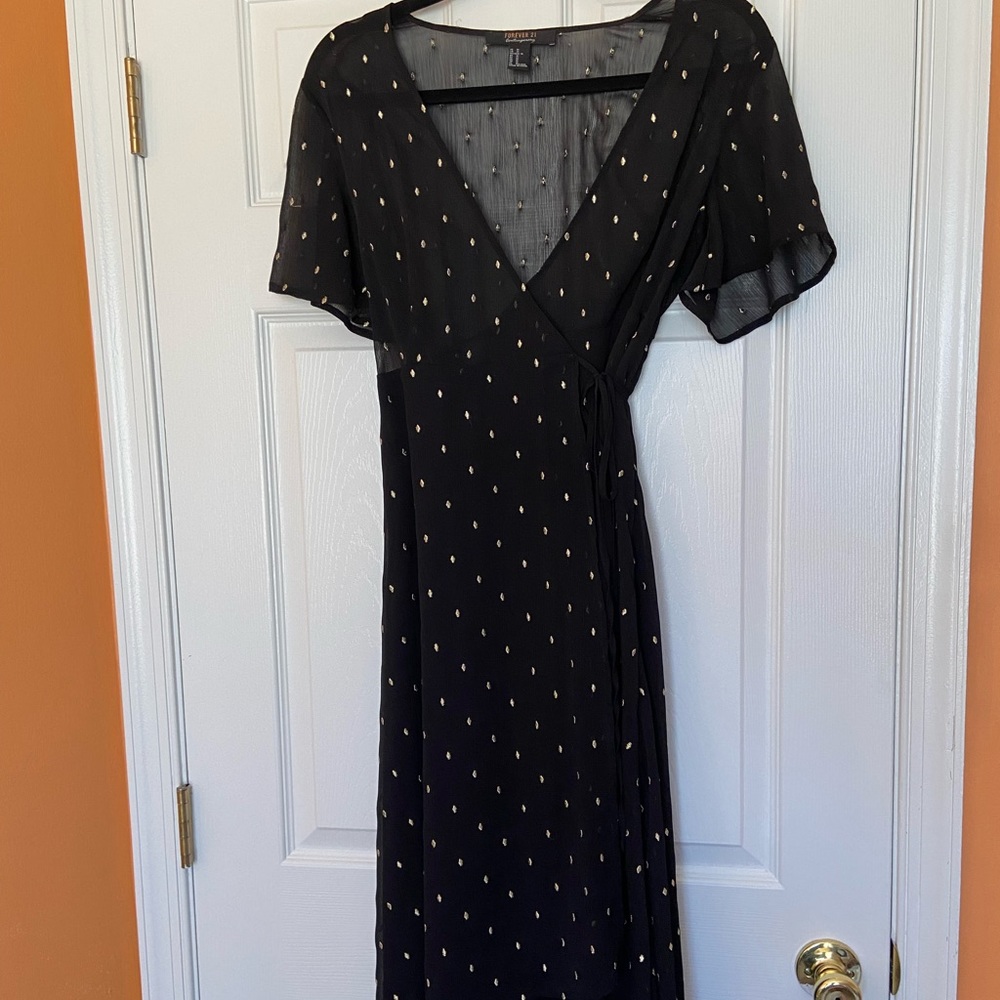 Mid length black wrap dress with gold detail. Lightly worn!!